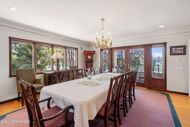 dining room featuring recessed lighting, light wood-style flooring, ornamental molding, a chandelier, and baseboards