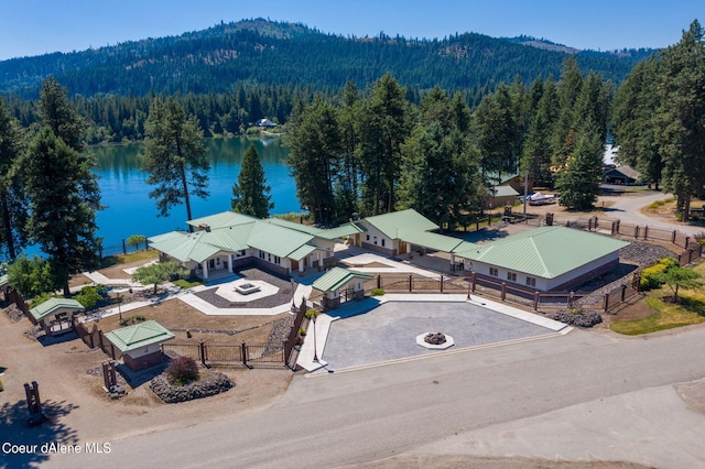 drone / aerial view featuring a water view and a view of trees