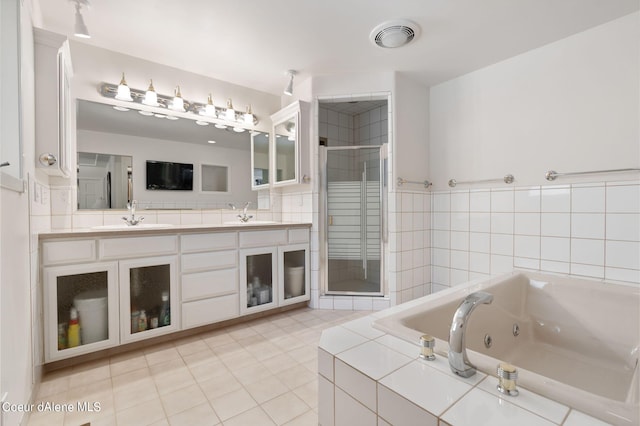 bathroom with double vanity, visible vents, a stall shower, a sink, and a tub with jets