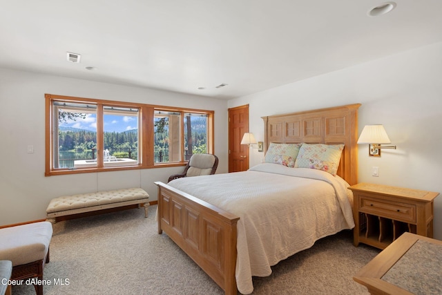 bedroom with light carpet and visible vents