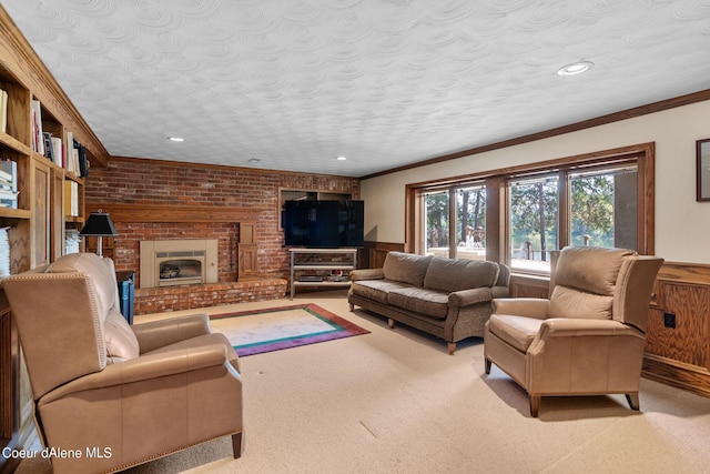 carpeted living area with ornamental molding, wainscoting, and a brick fireplace