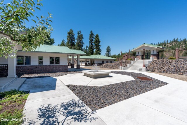 exterior space featuring a patio and a fire pit