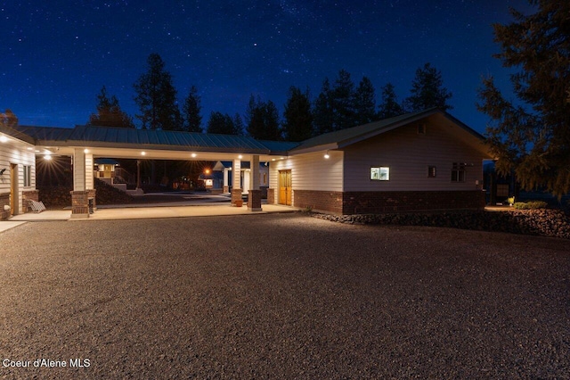 ranch-style home with brick siding and a patio