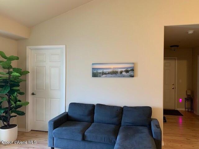 living room with lofted ceiling and light wood finished floors