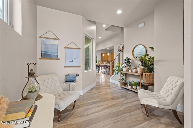 sitting room featuring baseboards, stairway, wood finished floors, and recessed lighting