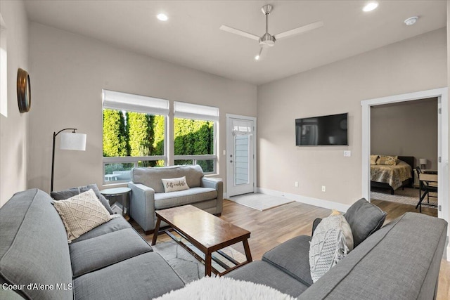 living room with baseboards, wood finished floors, a ceiling fan, and recessed lighting