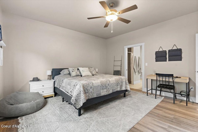 bedroom with ceiling fan and wood finished floors