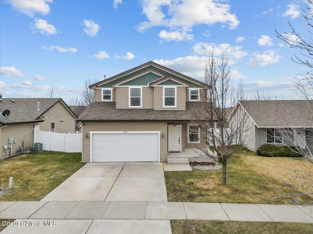 traditional-style home with a front lawn, fence, concrete driveway, an attached garage, and central AC unit