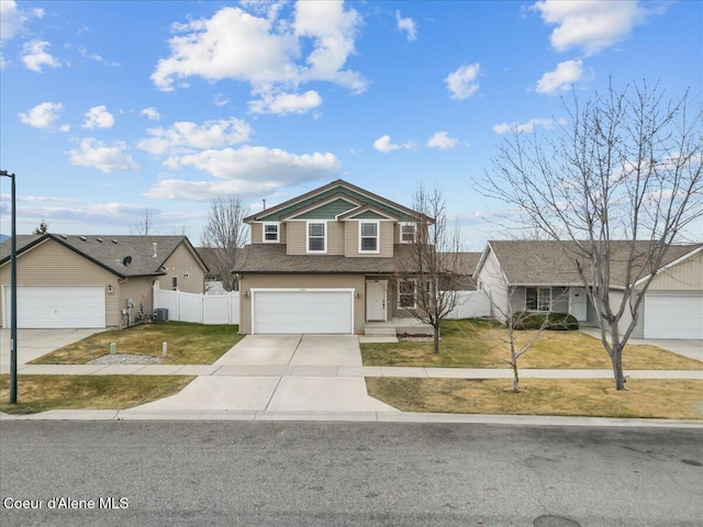 traditional-style house featuring central AC, concrete driveway, a front yard, and fence