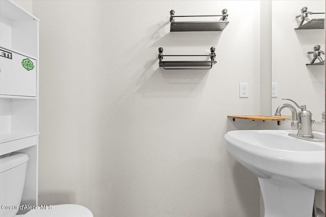 bathroom with toilet and a sink