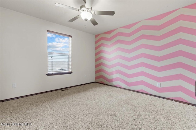 unfurnished room featuring visible vents, baseboards, and a ceiling fan