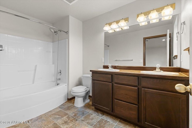 bathroom featuring double vanity, shower / washtub combination, toilet, and a sink