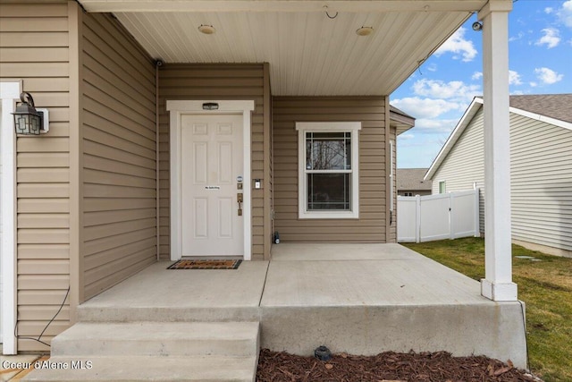 doorway to property featuring fence