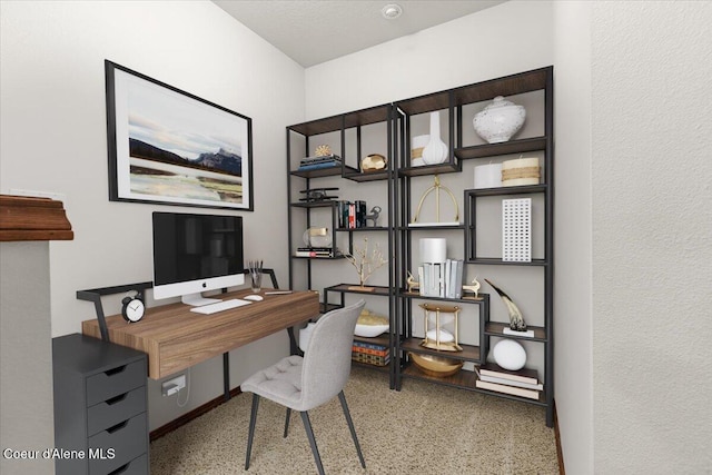 home office featuring speckled floor