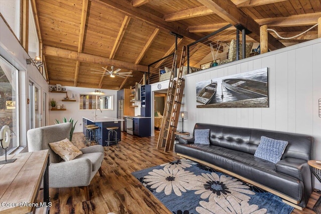 living room with high vaulted ceiling, beam ceiling, dark wood finished floors, and wood ceiling