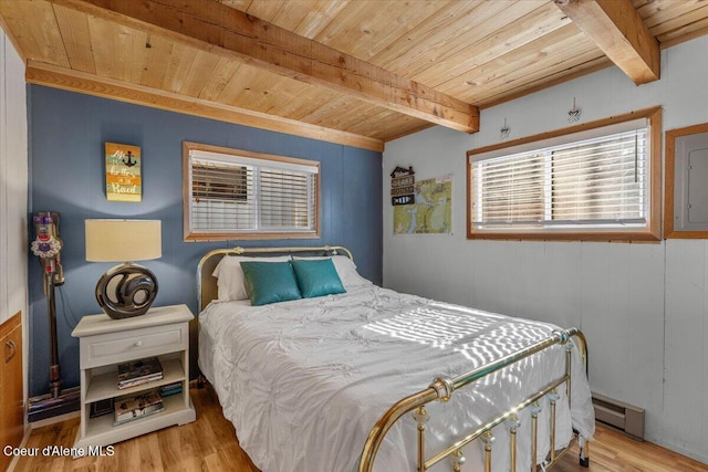 bedroom with baseboard heating, wooden ceiling, and wood finished floors