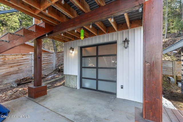 entrance to property featuring a patio area and fence