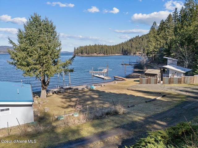 dock area featuring a water view and a wooded view