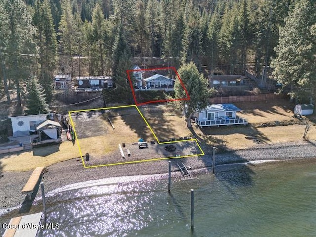 birds eye view of property with a forest view