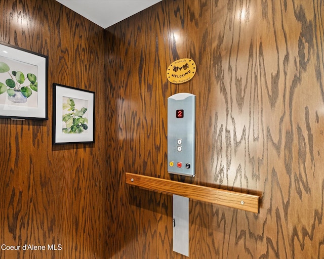 room details with wooden walls and elevator