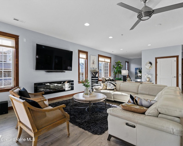 living room with a ceiling fan, recessed lighting, visible vents, and light wood-style flooring