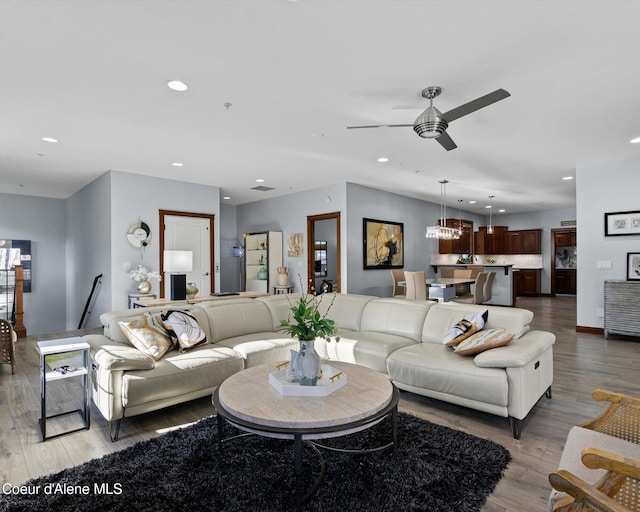 living area featuring recessed lighting, ceiling fan, baseboards, and wood finished floors