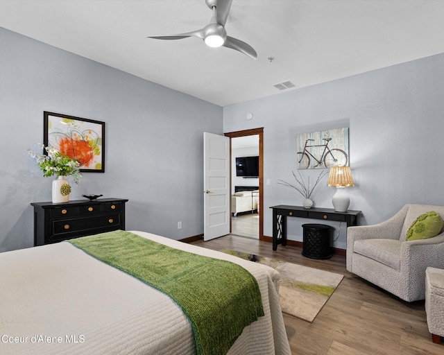 bedroom with visible vents, ceiling fan, baseboards, and wood finished floors