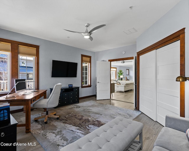 office area with a ceiling fan and wood finished floors