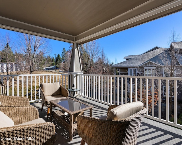 wooden terrace with an outdoor hangout area