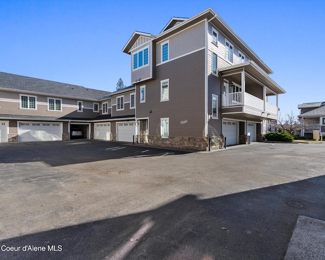 view of property exterior featuring a garage and stone siding