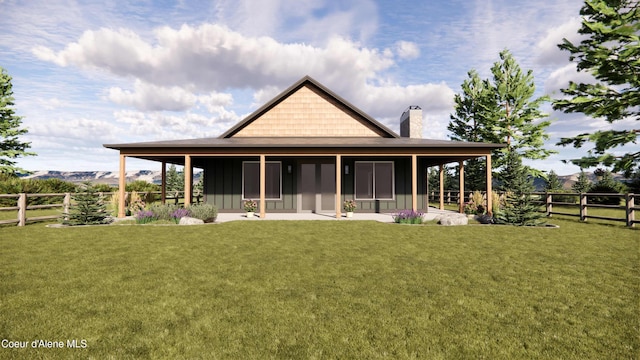 rear view of property with a lawn, board and batten siding, and a chimney