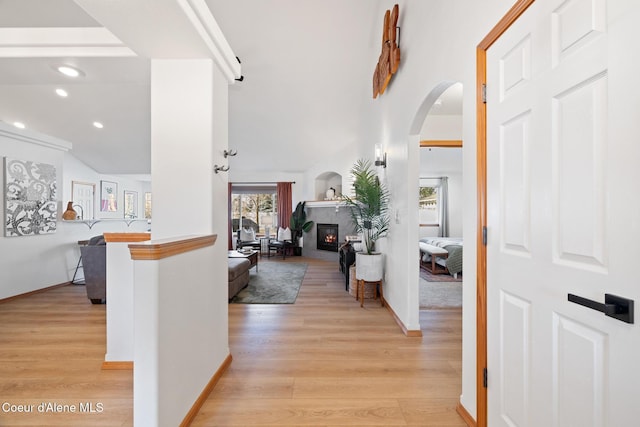 2645 W Bolivar Ave, Coeur Dalene, ID 83815 - foyer entrance with recessed lighting, arched walkways, light wood-style floors, baseboards, and a glass covered fireplace