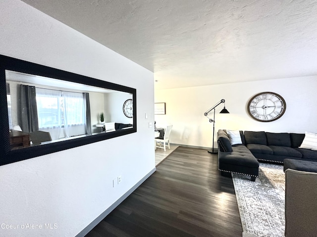 living area featuring a textured ceiling and wood finished floors