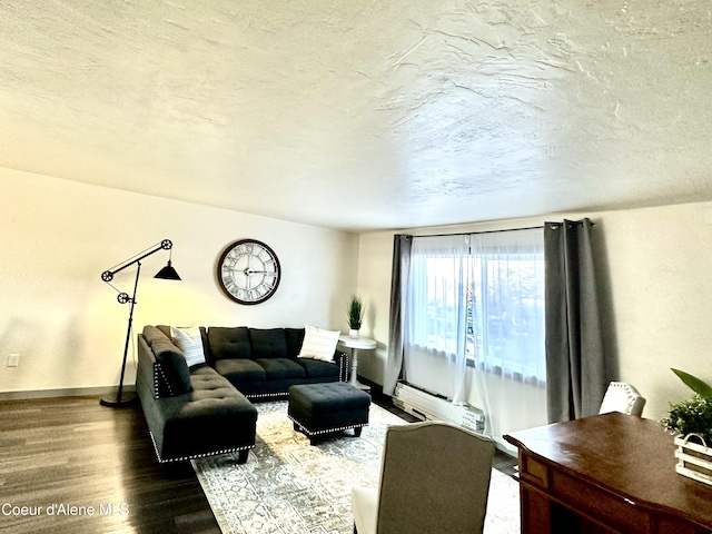 living room with a textured ceiling, a baseboard radiator, wood finished floors, and baseboards