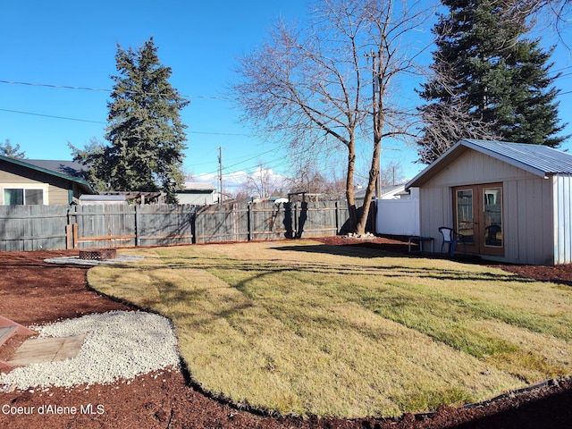 view of yard with french doors and fence