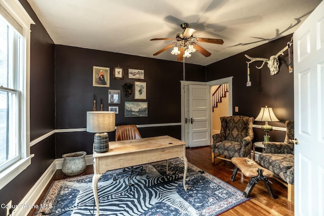 office with wood finished floors, a ceiling fan, and baseboards