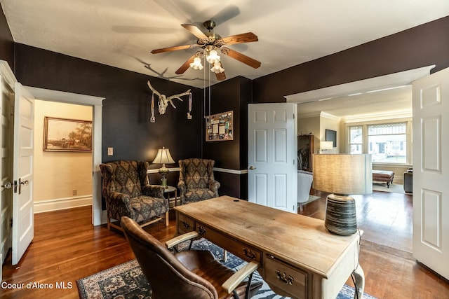 home office with wood finished floors, a ceiling fan, and baseboards