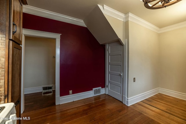 additional living space with wood-type flooring, visible vents, and baseboards