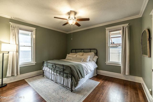 bedroom featuring ornamental molding, hardwood / wood-style flooring, and baseboards