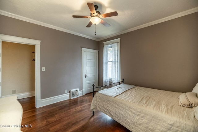 bedroom featuring visible vents, ornamental molding, ceiling fan, wood finished floors, and baseboards