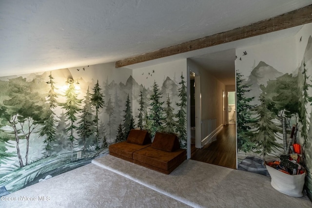 interior space featuring beamed ceiling and carpet flooring