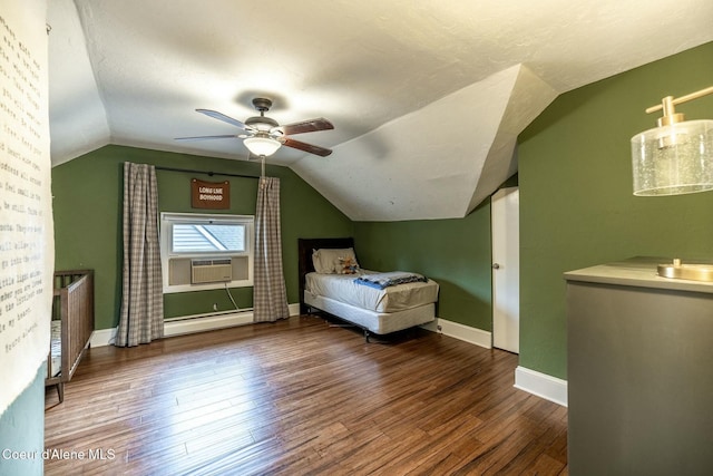 unfurnished bedroom with a baseboard heating unit, wood-type flooring, vaulted ceiling, and baseboards