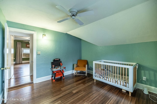 bedroom with lofted ceiling, a textured wall, a ceiling fan, baseboards, and wood-type flooring