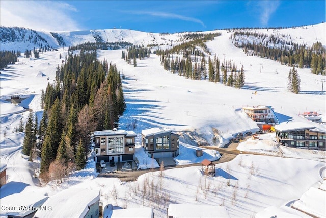 snowy aerial view featuring a mountain view