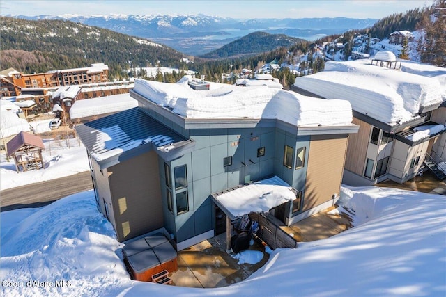 snowy aerial view featuring a mountain view