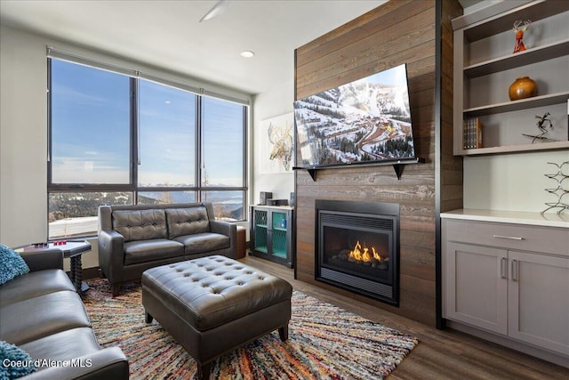 living room featuring dark wood finished floors and a glass covered fireplace