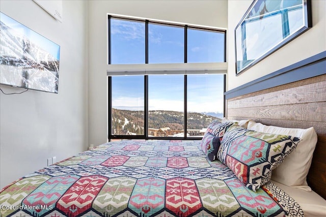 bedroom with a high ceiling and a mountain view