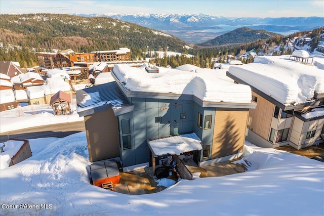 snowy aerial view featuring a mountain view