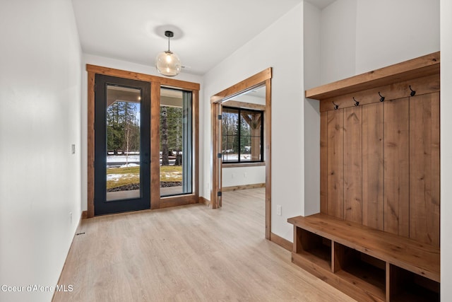 mudroom featuring baseboards and light wood-style floors