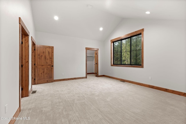 unfurnished room featuring visible vents, baseboards, light colored carpet, vaulted ceiling, and recessed lighting